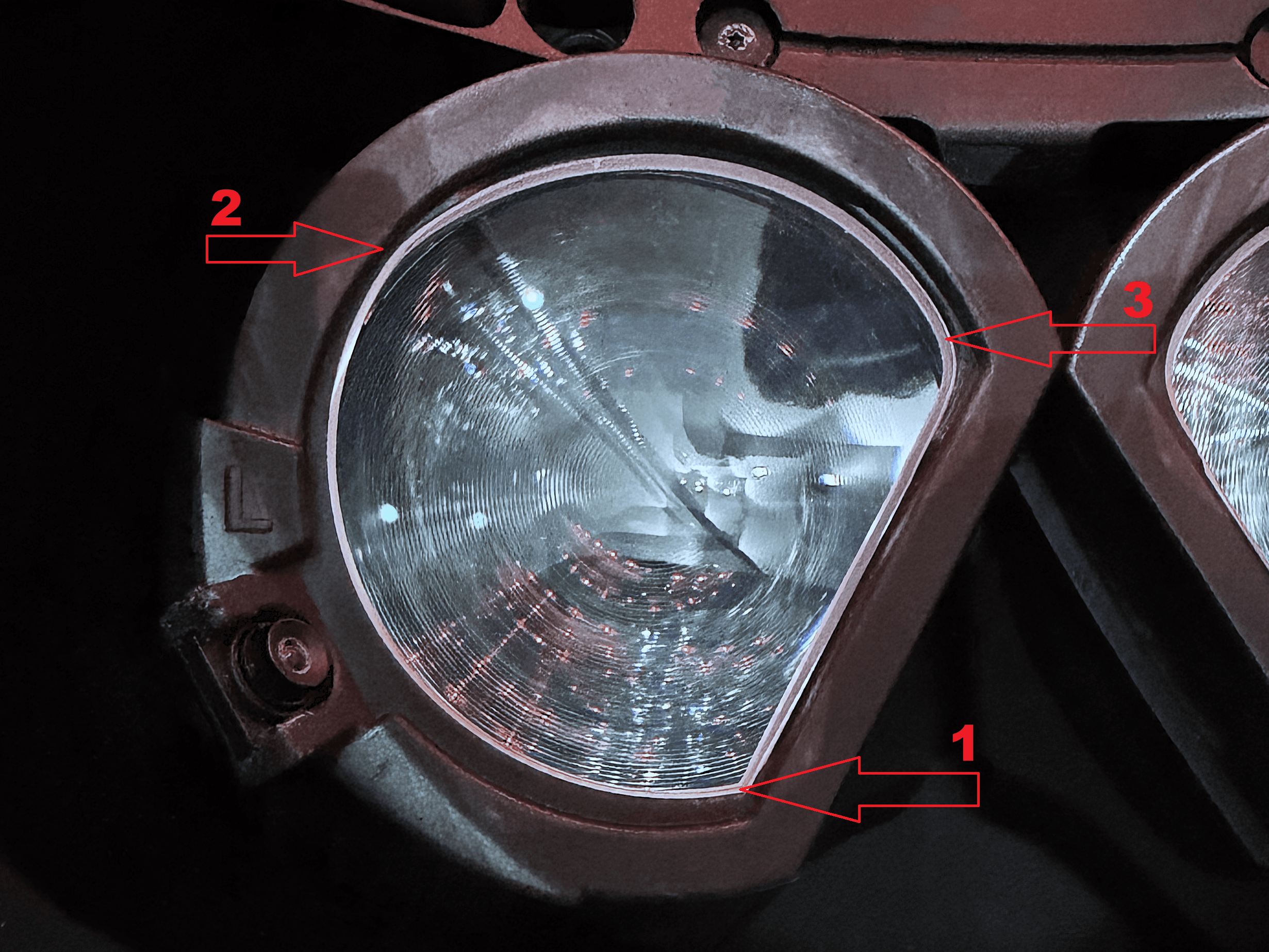 Left lens (L) in the new eye module, with red arrows showing the press order: 1 = lower (sharper) corner, 2 = upper outer edge, 3 = upper inner edge