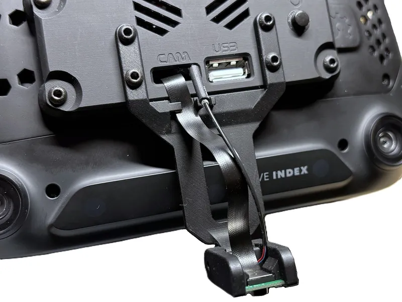 Face tracking module arm installed at an angle to avoid cable tension